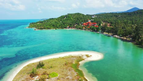 peaceful calm lagoon with coral reefs under turquoise water, exotic beach under shadow of tropical trees forest in thailand