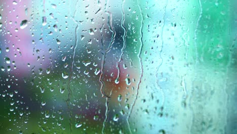 water flowing down on a glass window. raindrops on window pane. rainy weather. background of rain. close-up.