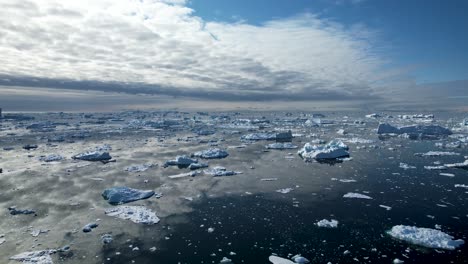 bay full of icebergs, cloud reflection, drone opening shot