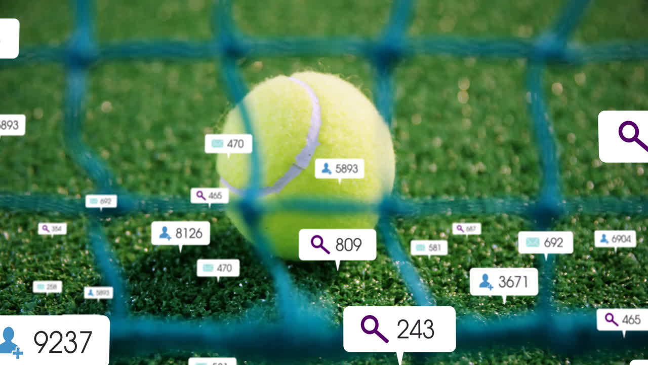 Yellow tennis ball lying on green turf behind blue net, showing digital icons and number labels
