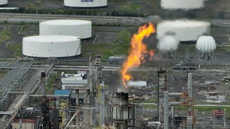 Oil-refinery-aerial-of-flames-in-front-of-industrial-background