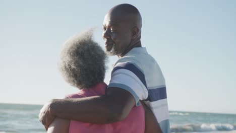 Feliz-Pareja-Afroamericana-Mayor-Caminando-Y-Abrazándose-En-La-Playa,-En-Cámara-Lenta