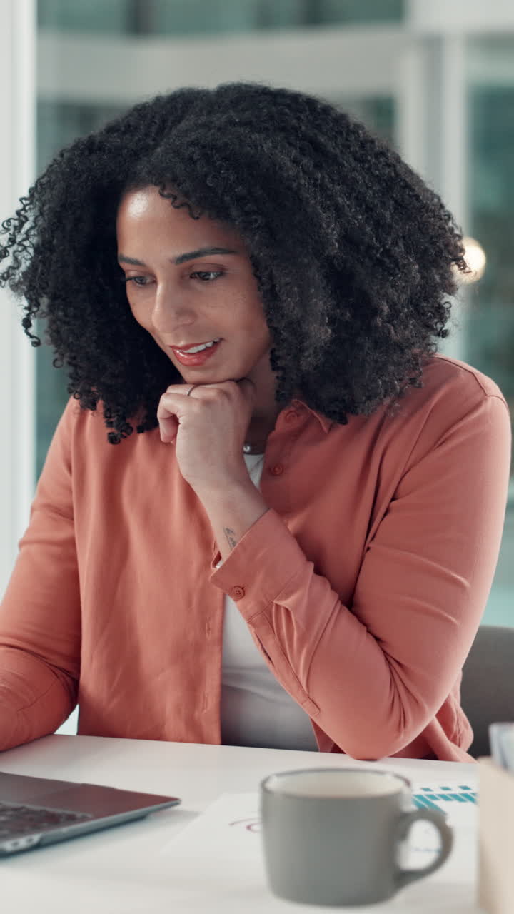 Young Woman Working on Laptop and Smiling in Office