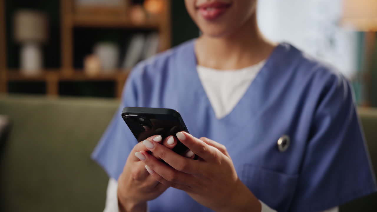 Nurse using smartphone indoors