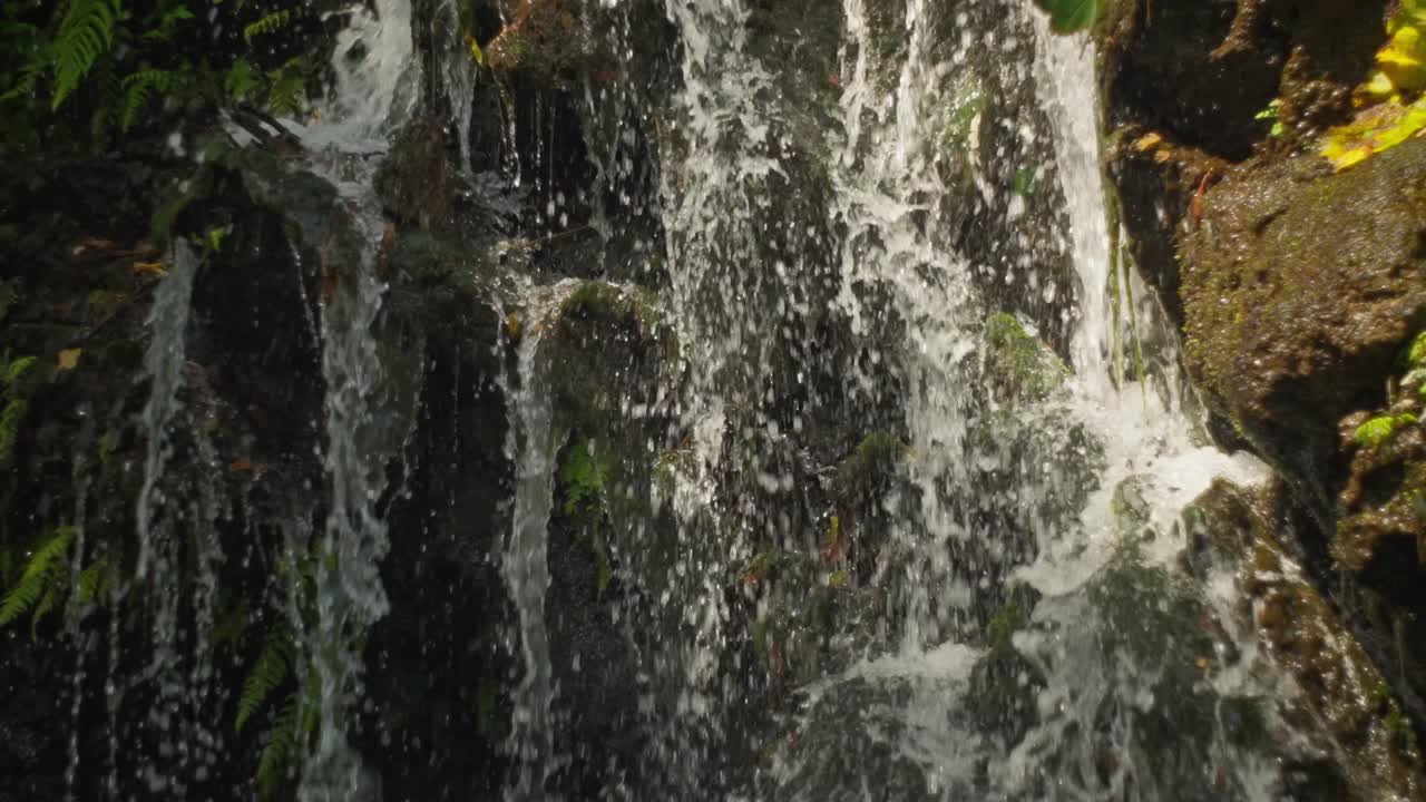SLOW-MOTION ZOOM OUT SHOT OF A WATERFALL AND WATER SPRING AT URUAPAN'S NATIONAL PARK