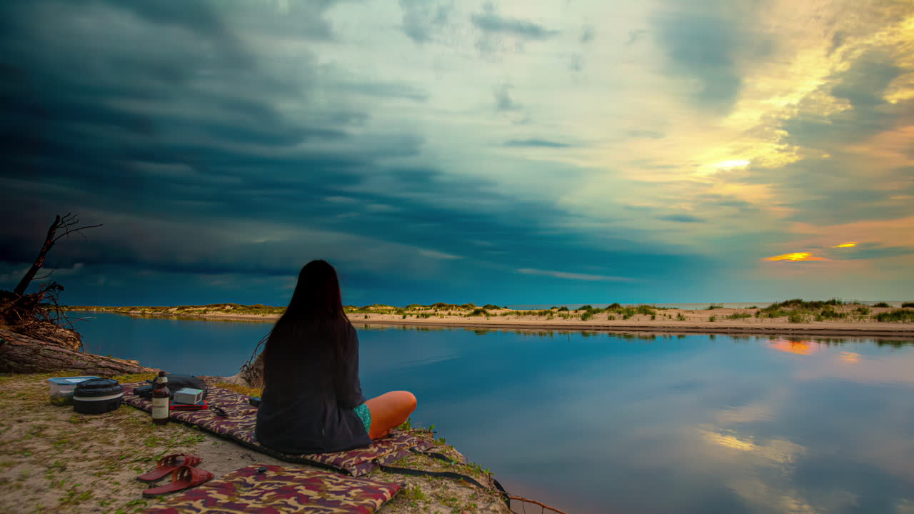 Contemplative Moments by the Water at Sunset