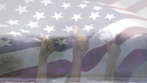 animación de la bandera de los estados unidos soplando sobre las manos en un gesto de acuerdo sobre el paisaje de la playa