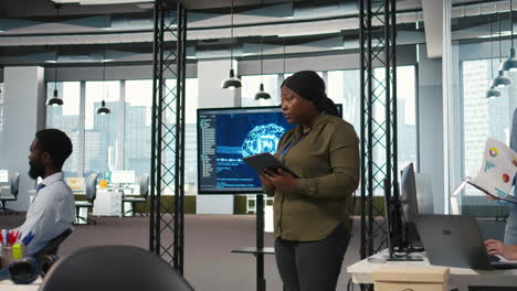 female programmer coding ai algorithms on tablet to debug software issues