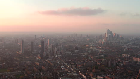 wide aerial shot over south london at sunset looking towards city centre