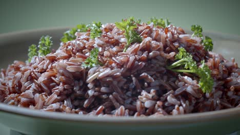 Brown-rice-with-parsley-on-top-turning-on-plate