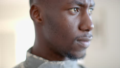 young african american soldier looks thoughtfully to the side, with copy space