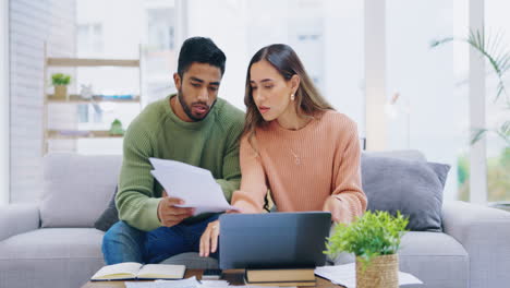 Home,-documents-and-couple-stress-on-sofa