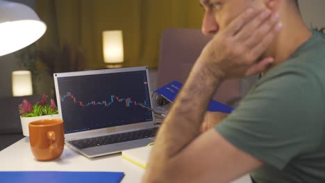 the man looking at the cryptocurrency chart is unhappy. loss in the stock market.