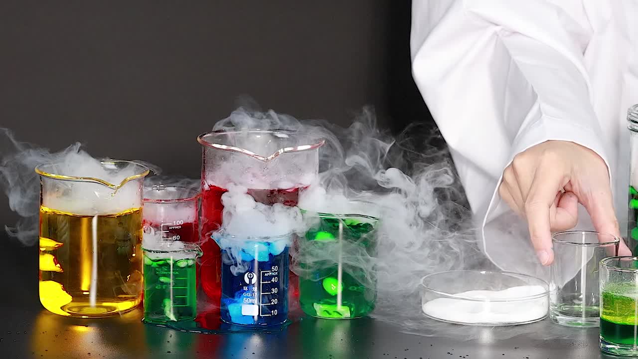 A series of colorful beakers emit smoke on a lab table, showcasing a vibrant chemical reaction.