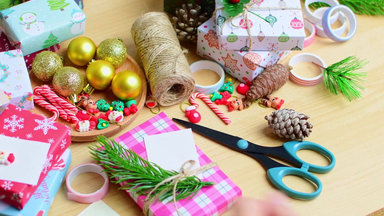 Woman preparing christmas gift wrapping on a wooden table