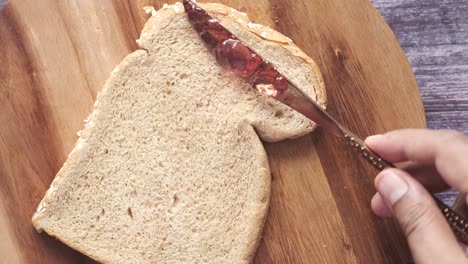 spreading butter on a slice of bread