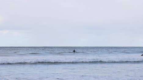 surfer riding waves at great ocean road