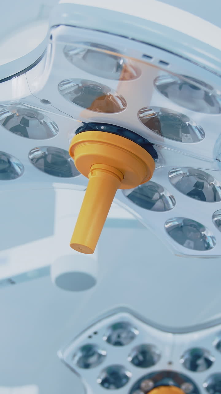 Modern medical lamps on ceiling. Lightning equipment in the operating room. Surgical lamps at a daytime in clinic. Vertical video