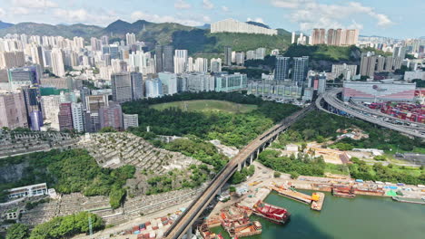 mtr pass over bridge near cemetery in tsuen wan, hong kong