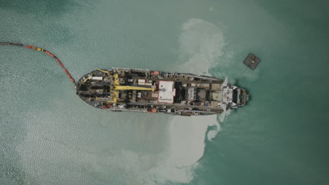 tracked aerial hyperlapse of sand dredging ship in the bari, italy harbor