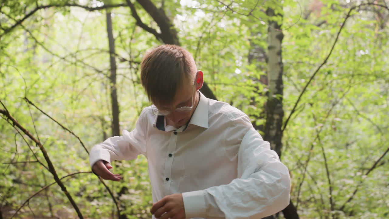 Close view of botany student removing white coat in forest surrounded by lush greenery and natural light, emphasizing field research preparation, outdoor scientific exploration, and ecological study