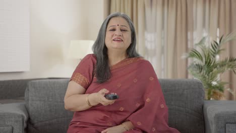 Cheerful-Indian-old-woman-watching-TV