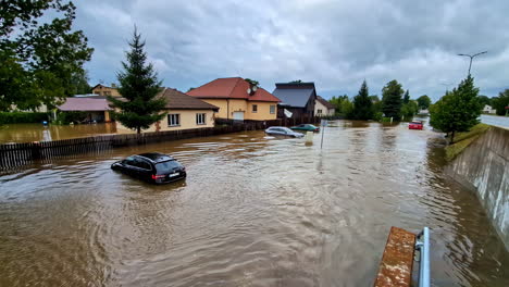 flooded street with submerged cars and houses