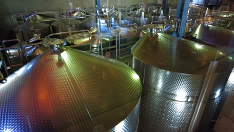 stainless steel tanks at the winery processing room - winemaking process