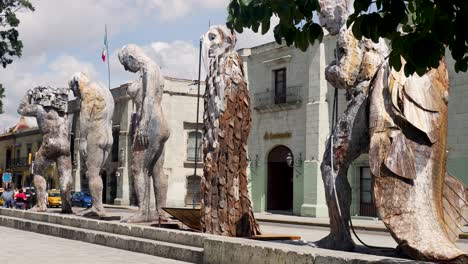slow motion landscape of giant metal sculptures art statue design installations zócalo museum park in oaxaca city downtown mexico travel tourism culture