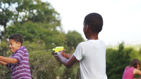 Grupo-De-Niños-Jugando-Con-Pistola-De-Agua