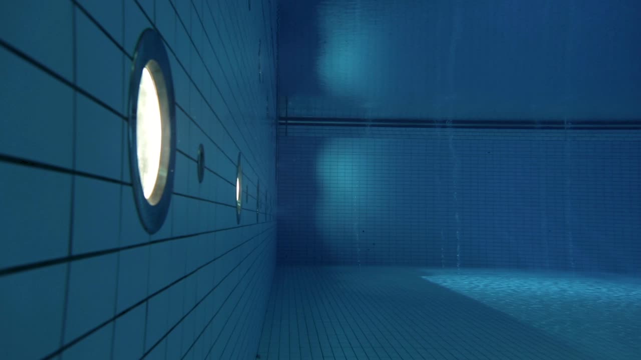 Underwater geometric shot of lights, bubbles and tiles at Olympic diving pool
