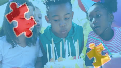 Animation of colourful puzzle pieces over children with birthday cake at party