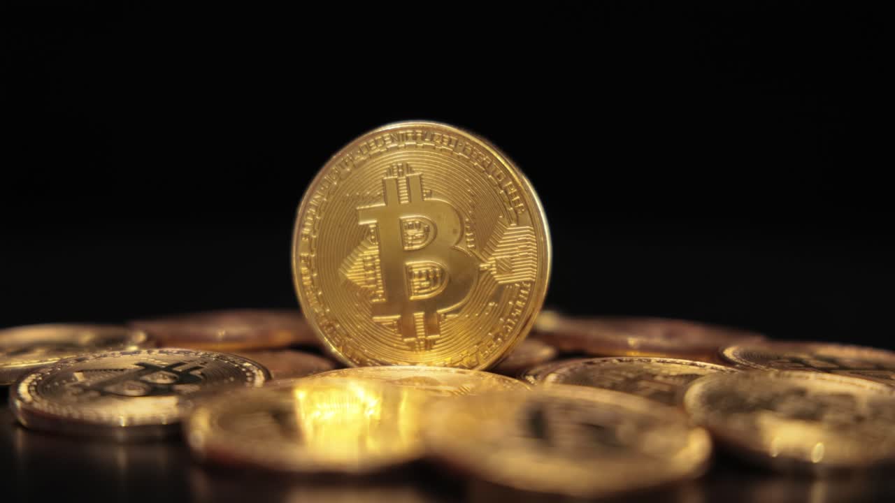 Gold Bit Coin BTC Cryptocurrency Coins on a black background. Bitcoin is a worldwide cryptocurrency and digital payment system called the first decentralized digital currency.