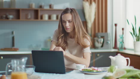 businesswoman using laptop at home. woman working on laptop at remote workplace