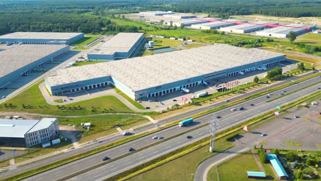 Aerial-view-of-warehouse-storages-or-industrial-factory-or-logistics-center-from-above