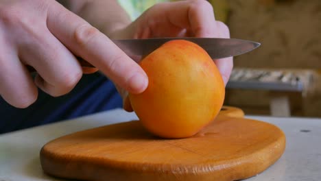 slicing fresh peaches on a wooden board