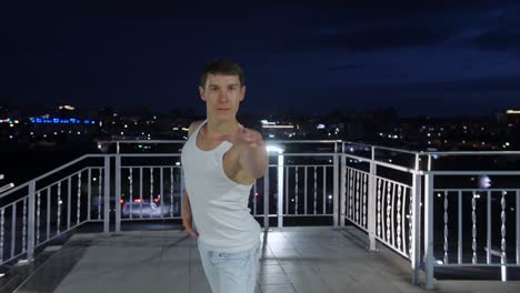 man dancing on rooftop at night