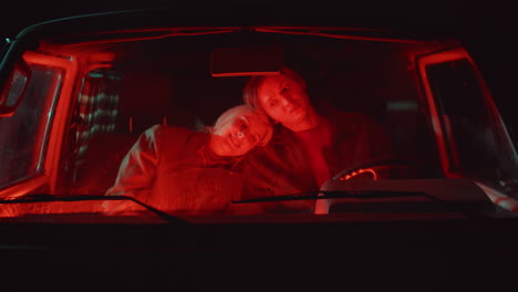 Affectionate-Couple-Sitting-in-Car-at-Night