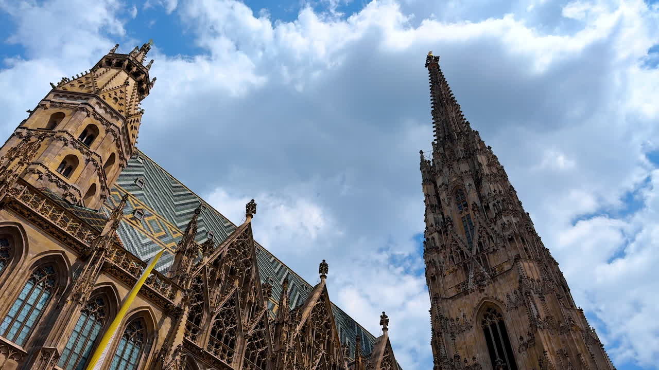 Vienna, Austria - June 9, 2025: Roof and towers of Saint Stephen's Cathedral in Vienna, Austria. Low angle view at the historical landmark on cloudy day