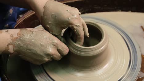 woman hands on pottery wheel. craftsman artist shapes pot