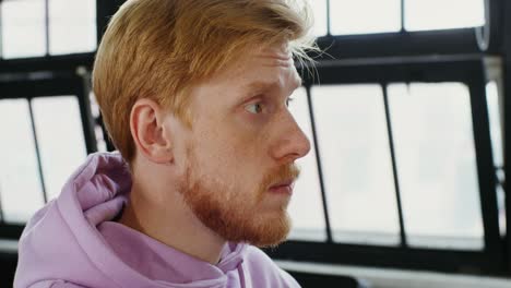 man with red hair in profile view