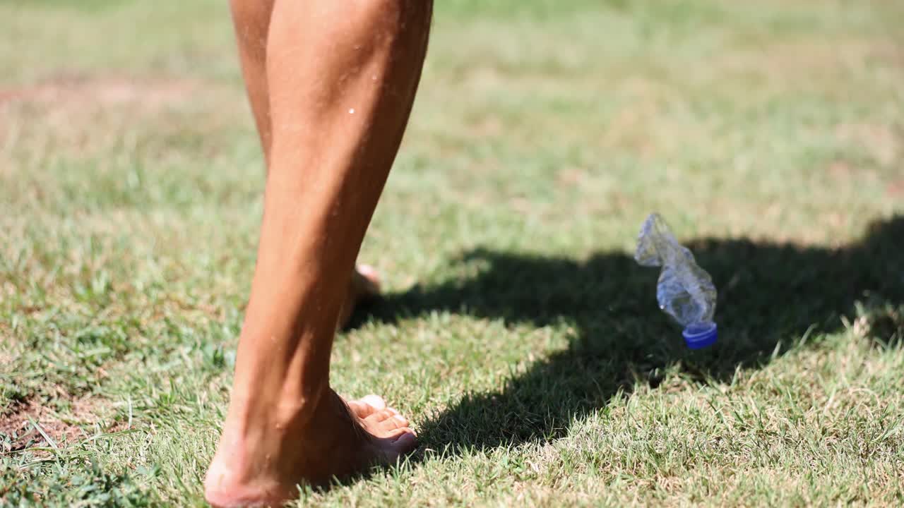Leg and water bottle on grass