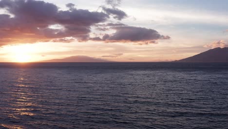 low panning aerial shot of lanai and west maui at sunset from wailea in south maui, hawai'i