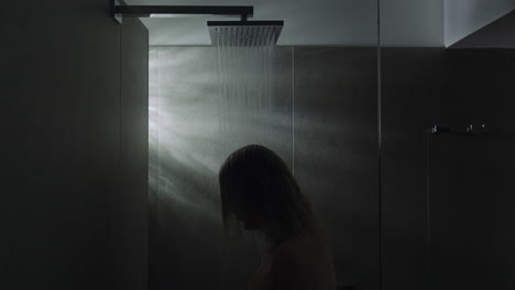 woman under the shower calming down with water