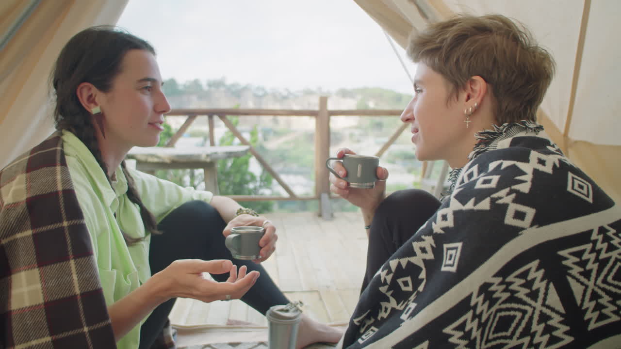 Female Friends Drinking Tea and Speaking in Glamping Tent