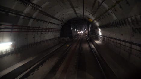 subway, underground train rails going through tunnel