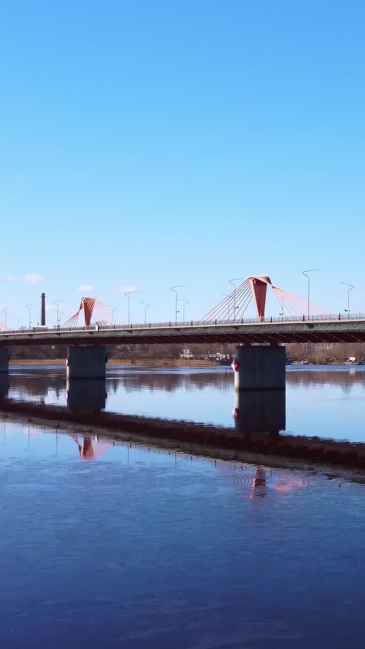 Vertical aerial shot of Southern Bridge rising over traffic in Riga, Latvia