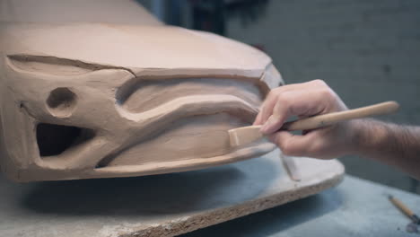 sculpting a car model from clay