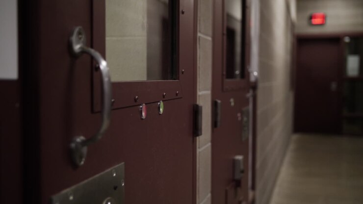 Prison doors in hallway of jail or prison facility