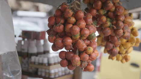 slow motion footage at a market of a bunch of tomatoes grouped together at a vegetable stand